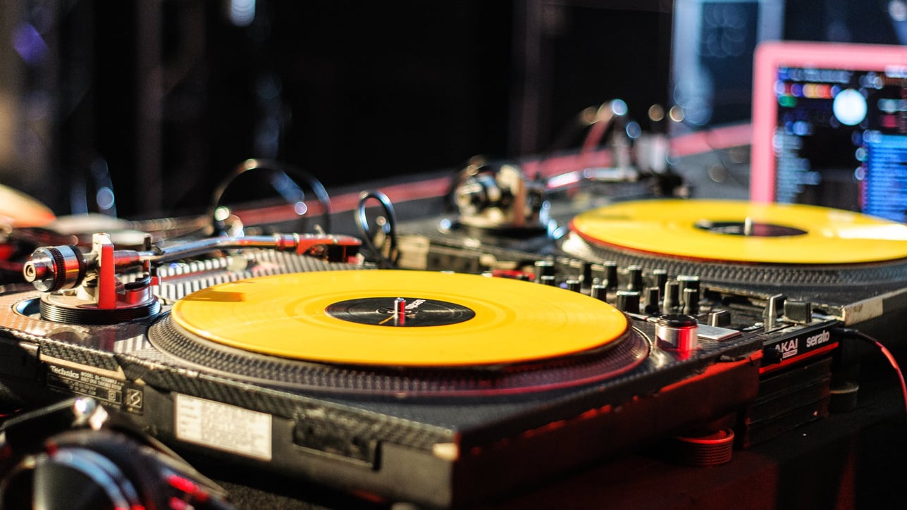 DJ console with records in nightclub